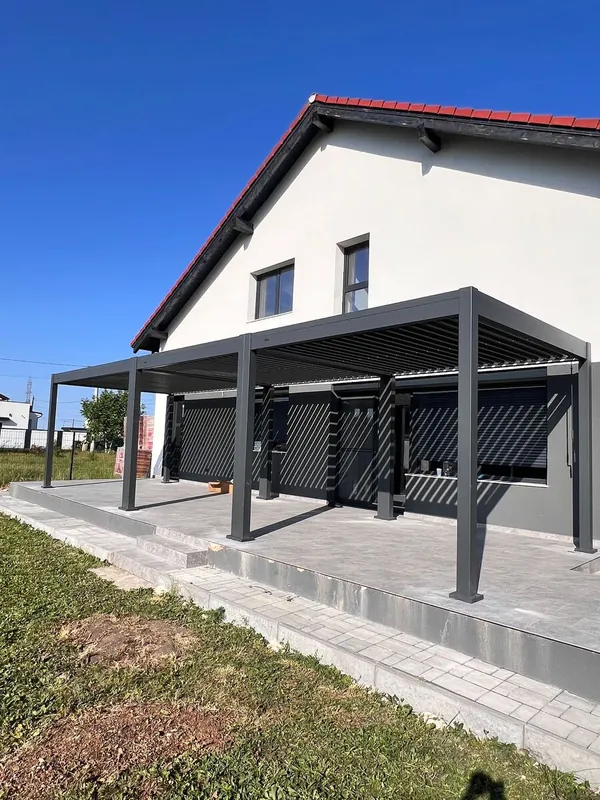 Three bioclimatic pergola modules joined along the length of a terrace